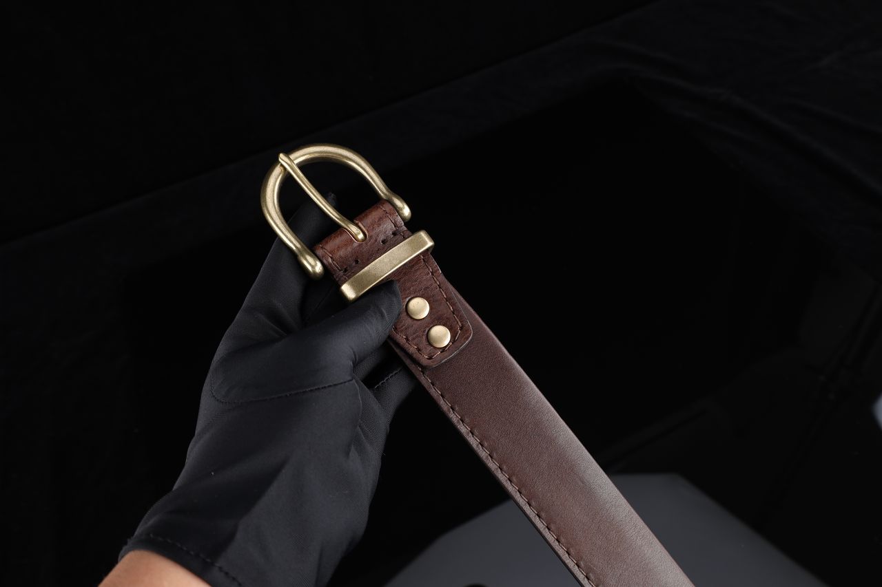 Elegant leather belt with brass buckle, perfect for fashion enthusiasts.